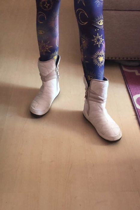 A reviewer seen wearing the white version of the boot.