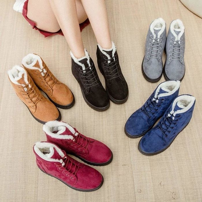 Faux suede lace-up boots with faux shearling lining, available in a variety of colors including red, brown, black, grey, and blue.
