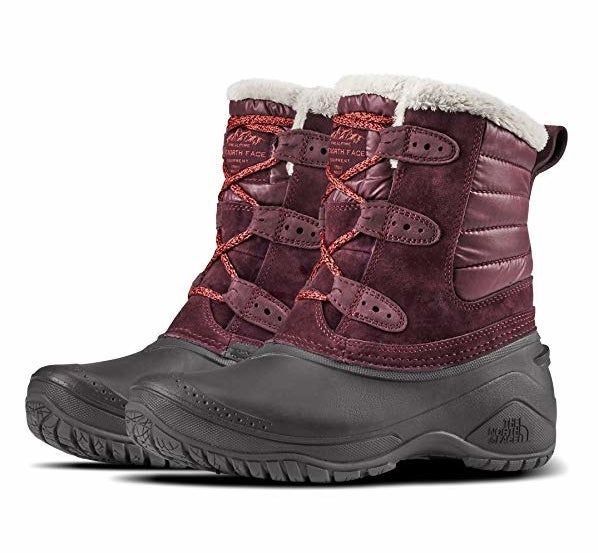 A chunky boot featuring a black sole with a striking red upper.