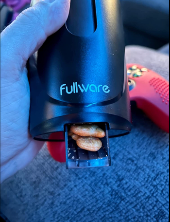 The bottom of the container features a small dispenser that releases two Goldfish crackers at a time.