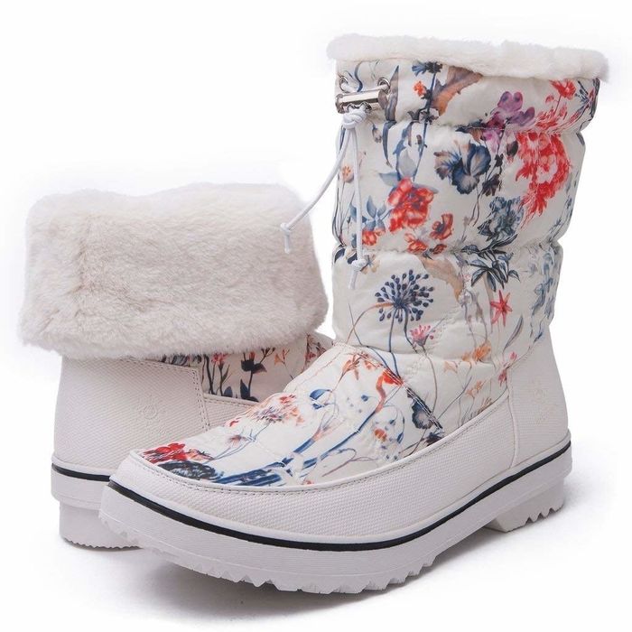 The white boots, decorated with flowers and featuring a cozy white shearling lining for extra warmth and comfort.