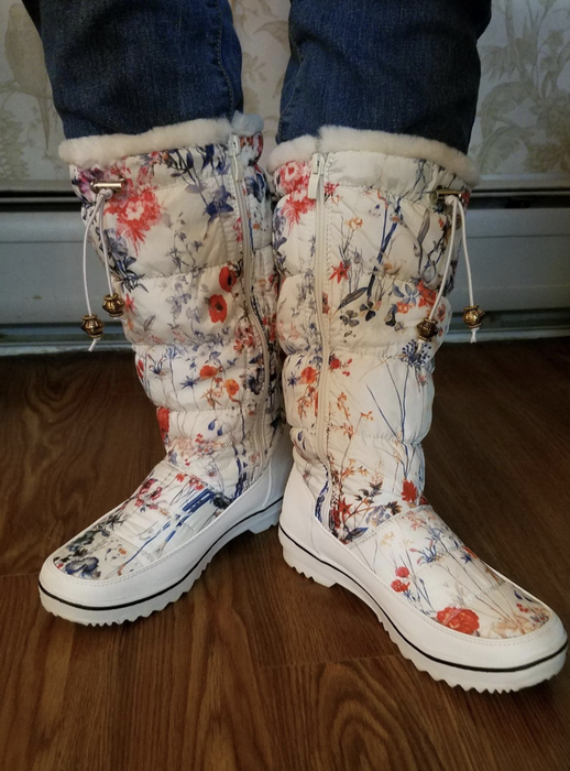 A reviewer models the boots, providing a firsthand look at their style and fit.