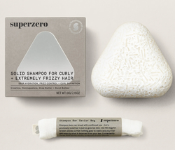 The shampoo bar along with its accompanying bag
