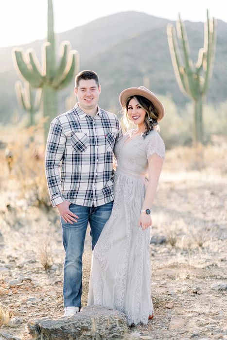 A reviewer in a long, light gray lace dress.
