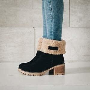 The chunky heel boot in black, with the top folded down to reveal the cozy faux shearling lining inside.
