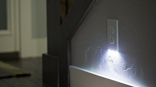 The outlet cover plate lighting up a dimly lit hallway.