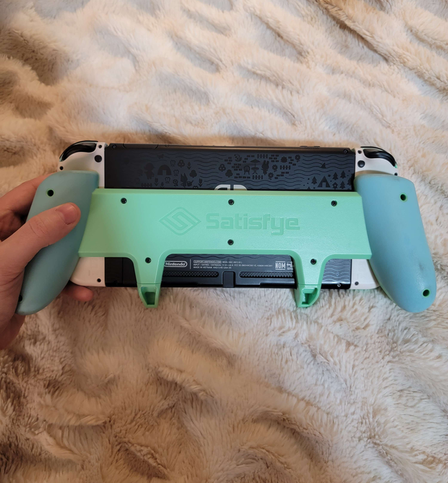 The back view of the grip securely attached to the Nintendo Switch.