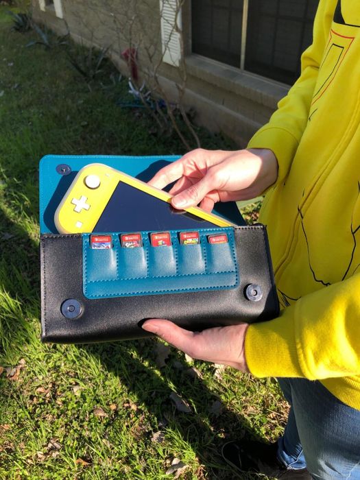 A Switch securely placed inside the Snorlax case, displaying the five game card slots as well.
