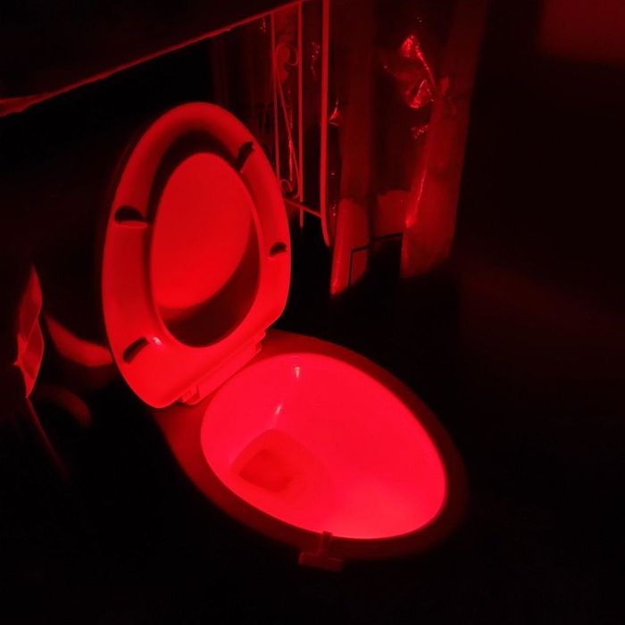 A customer review of a toilet glowing red, lighting up the space.