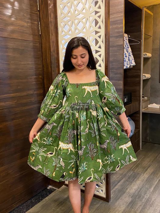 Model showcasing a knee-length dress with a striking tiger and jungle print.