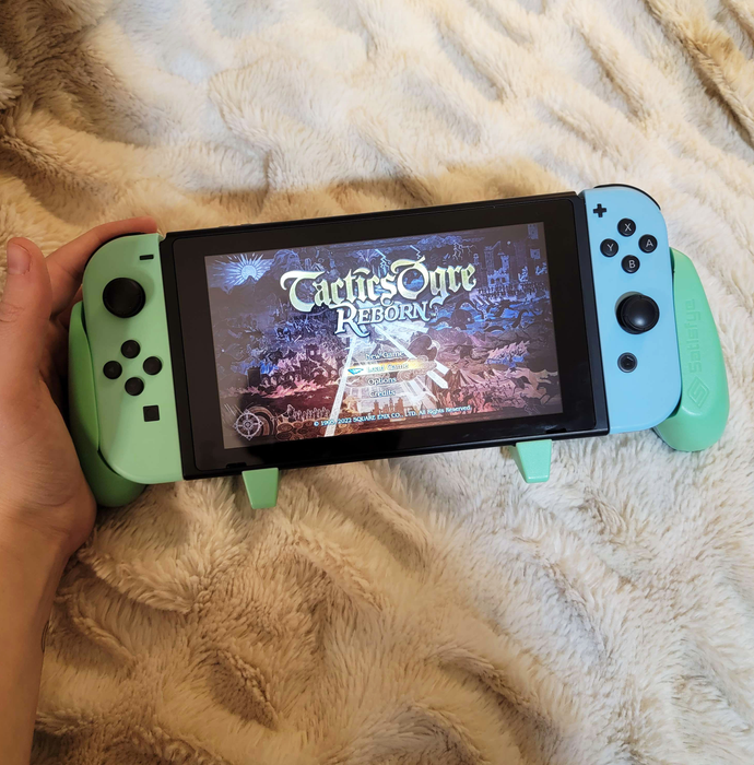 A blue and green grip attached to a Nintendo Switch console.