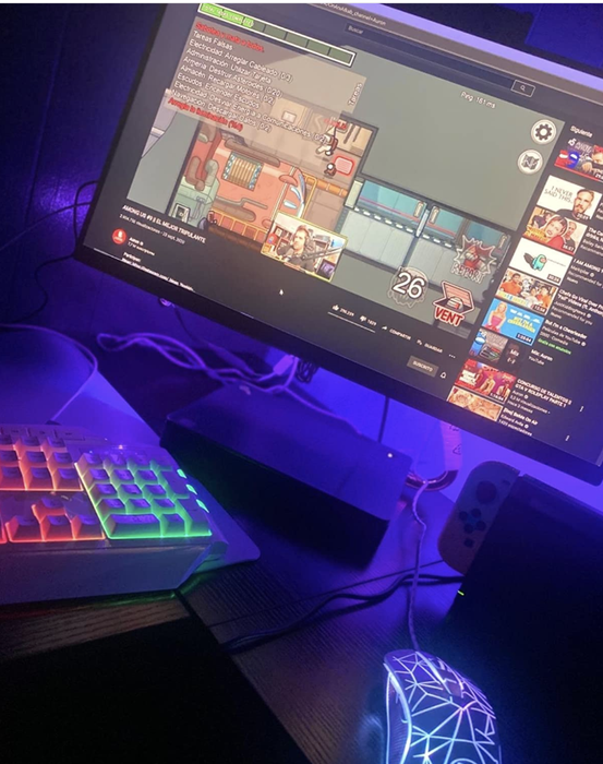 A computer’s backlight glowing purple from an LED strip.