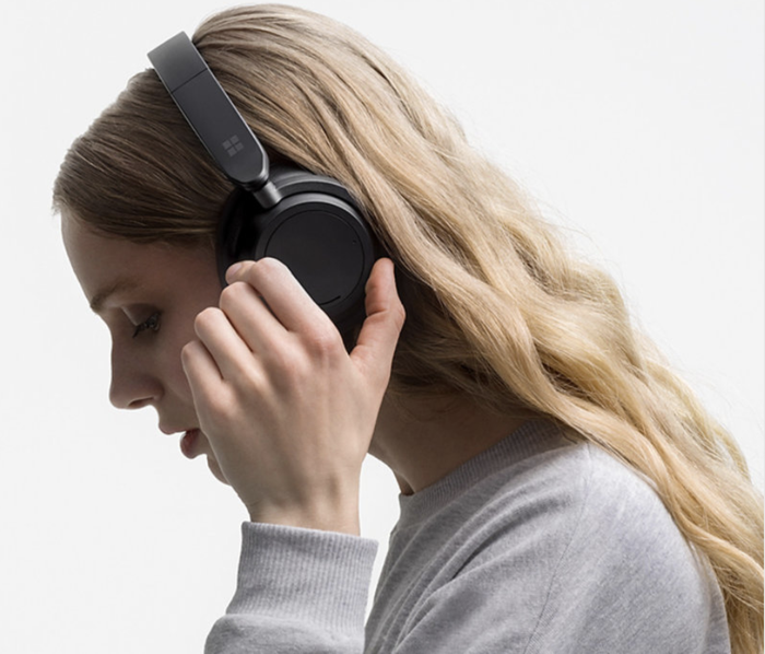A model wearing the black over-ear headphones.
