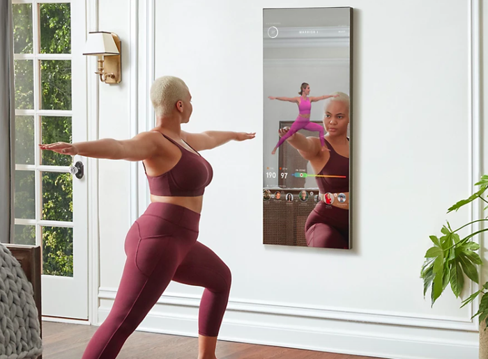 A person practicing yoga in front of the MIRROR.