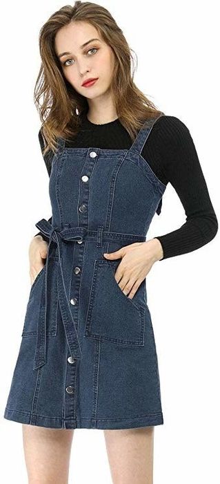 A model rocking a bib overall dress.
