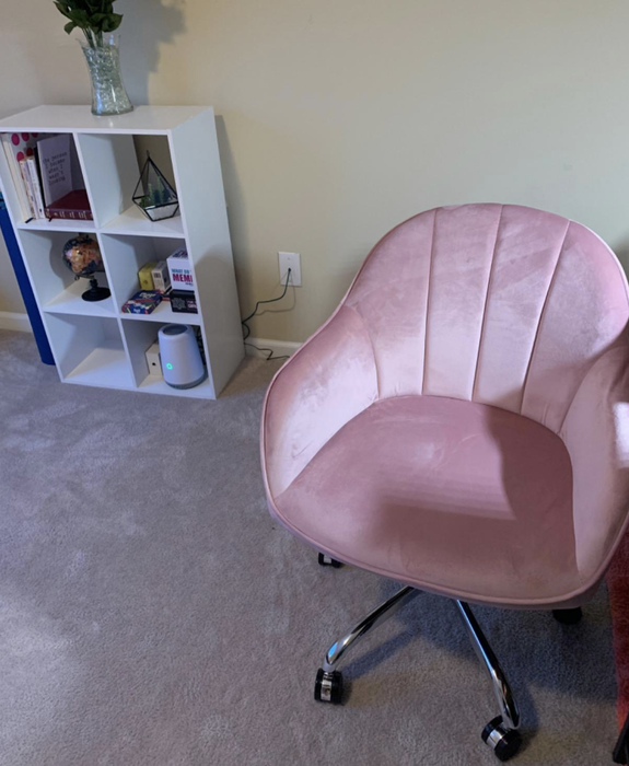 A reviewer image of the pastel pink version of the velvet swivel desk chair.