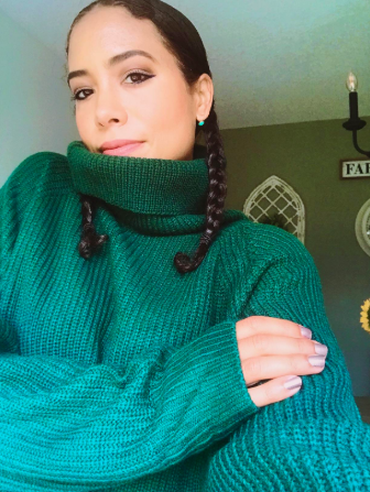 A close-up shot of the reviewer wearing the cozy turtleneck dress, highlighting the details.