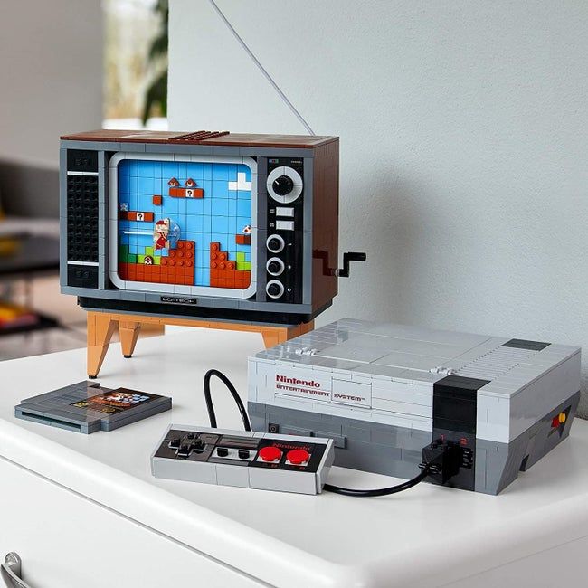 The Lego NES system placed beside a Lego TV and game cartridge.