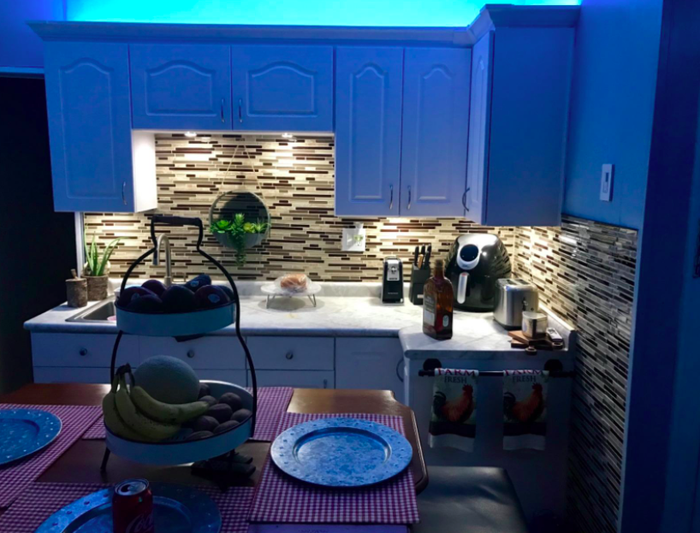 A customer review photo showing their cabinets illuminated with lighting both above and below.