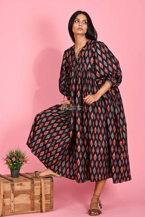 Model in a generously sized midi-length dress.