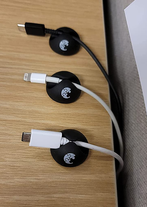 A close-up of three cords meticulously arranged and secured using the cable clips, ensuring a neat and clutter-free workspace.