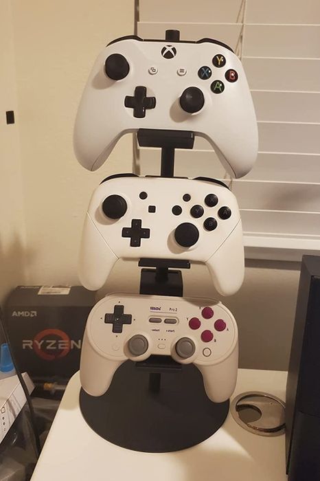 Three controllers neatly arranged on the stand.
