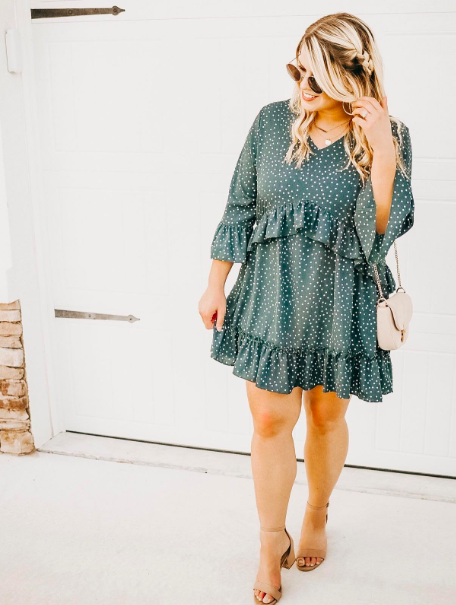 A customer photo review showing the ruffled-hem dress in green