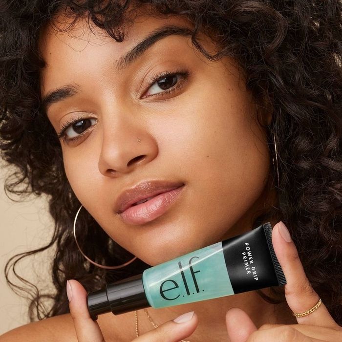 A model is holding the primer in their hands.