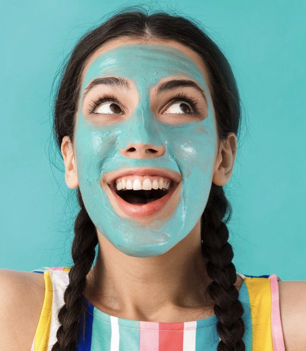 A person wearing the mask, dressed in blue, looking refreshed.