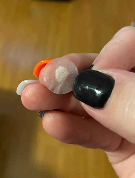 A reviewer shows a patch covered in a sticky substance.