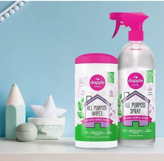 Dapple cleaning products placed on a counter next to decorative items.