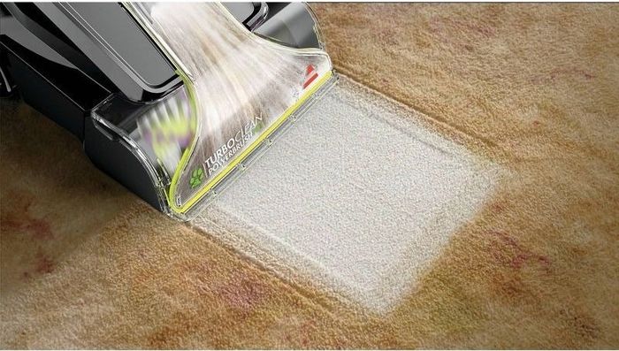 A carpet cleaner working on a carpet.