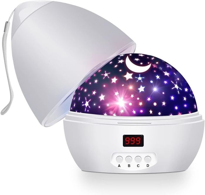 A star projector night light showcasing cosmic patterns, with an open lid and a digital control panel