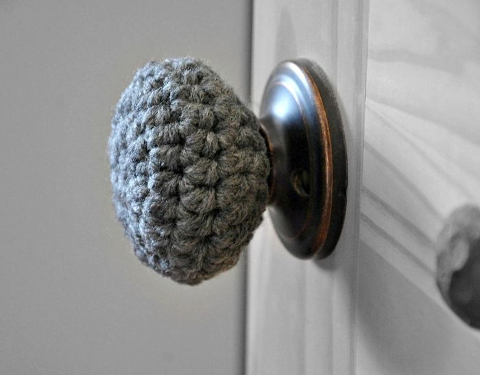 A door featuring a handcrafted knitted doorknob cover, perfect for adding a cozy touch to your home decor