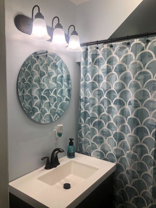 A reviewer image of the round mirror displayed in a room.