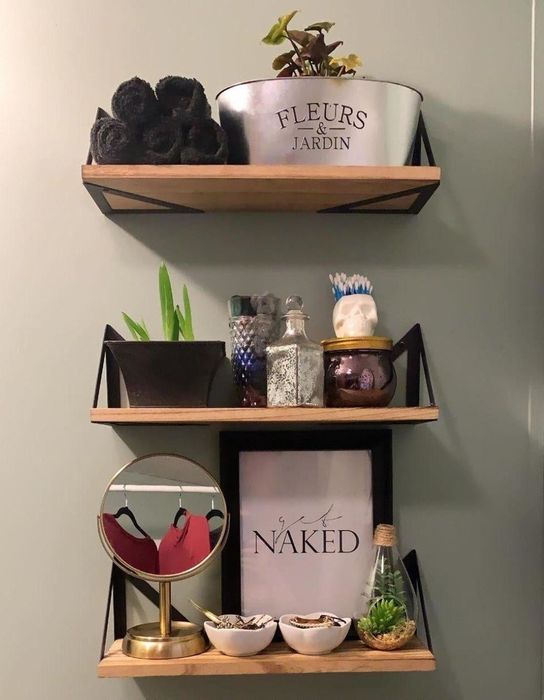 A photo from a reviewer showing the shelves positioned above the toilet.