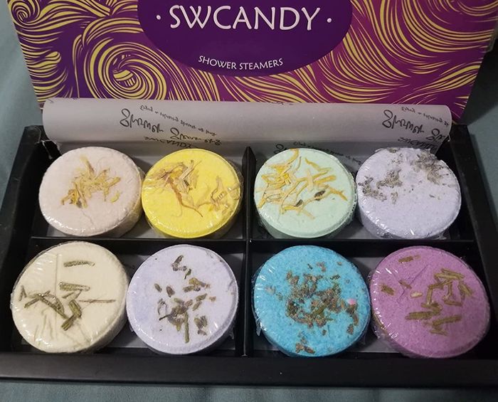 Image of reviewer showing a box of multi-colored steamers