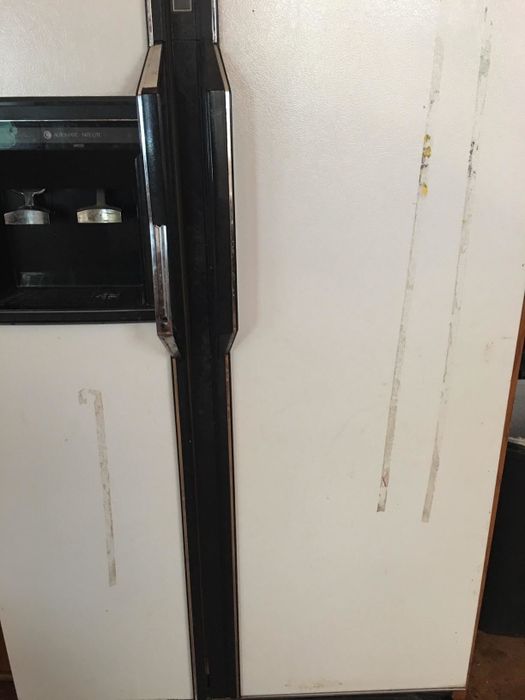 A refrigerator covered in sticky streaks, showcasing a common household mess