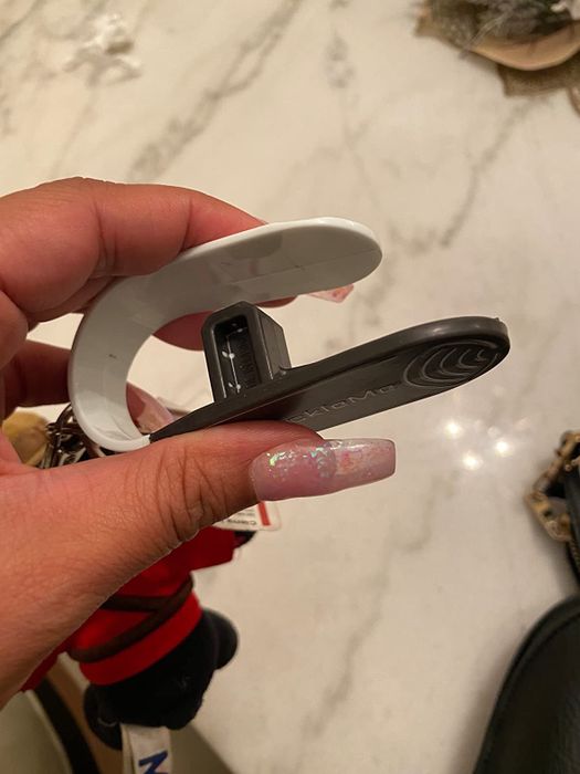 A person demonstrating the use of the car seat buckle release tool