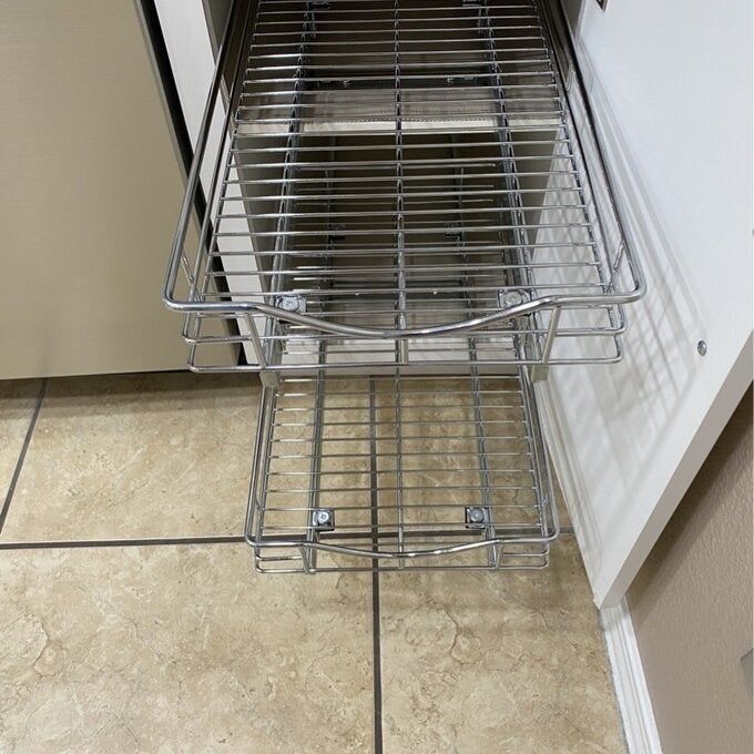 the slide-out cabinet drawer placed inside a kitchen cabinet