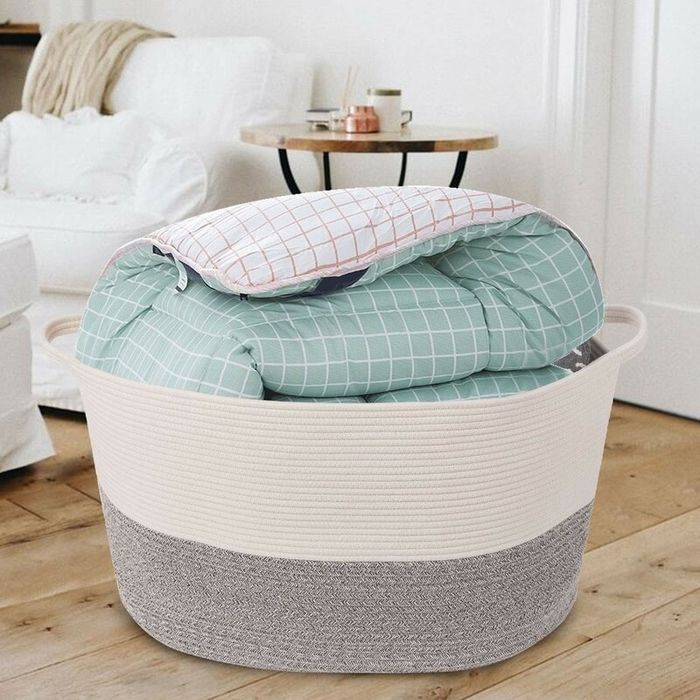 A fabric basket filled with blankets, neatly stored and ready for laundry day.