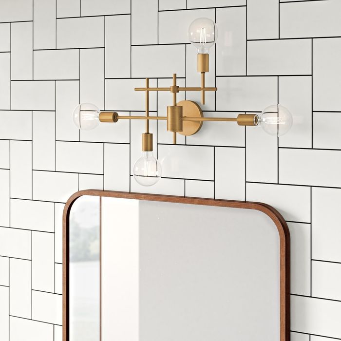 A sleek, wall-mounted light fixture with three exposed bulbs, perfectly situated above a bathroom mirror.