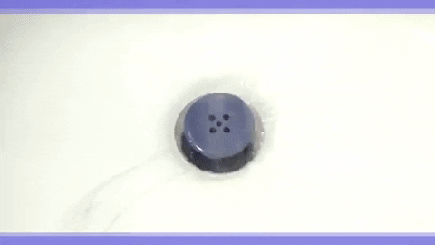 A gif showing the TubShroom catching stray hairs before they can cause a drain clog in the shower.