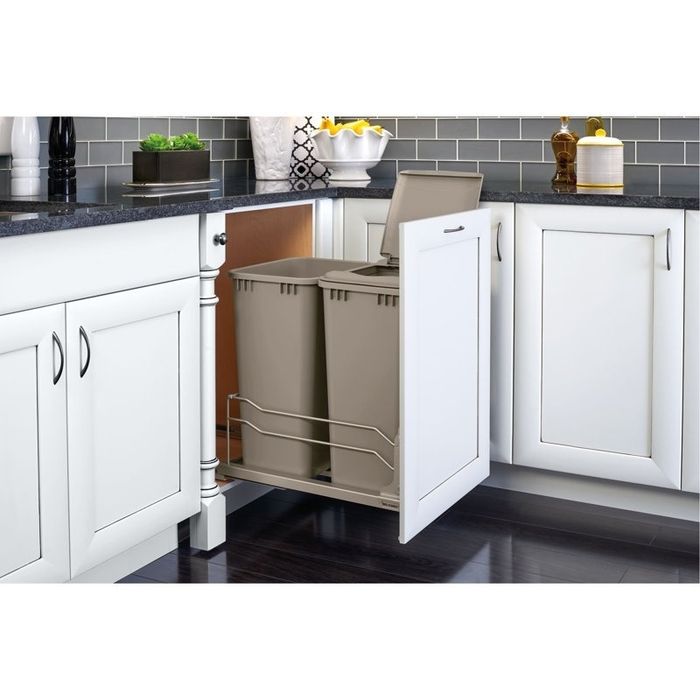 A kitchen cabinet featuring a convenient pull-out trash system to keep your kitchen clean and organized.