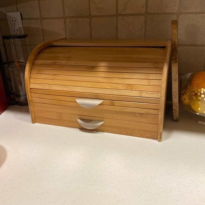 A bread box placed on the kitchen counter.