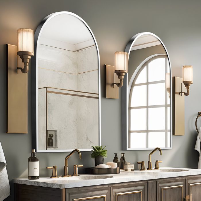 Two arched mirrors positioned above a double-sink vanity, enhancing both height and space in the bathroom.
