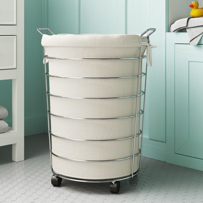 The rolling laundry hamper placed in a bathroom.