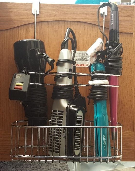 The same hair tools now neatly organized in a metal wire basket hanging organizer