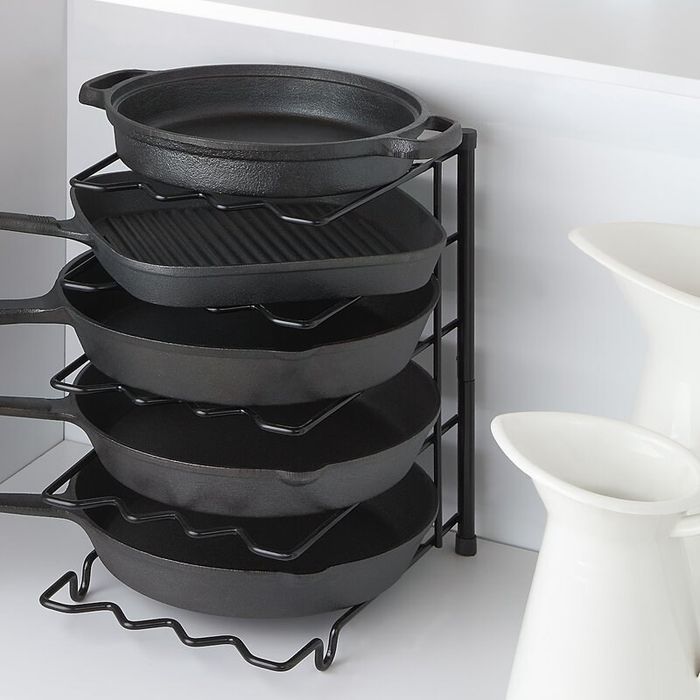 A sturdy kitchen divider, currently holding a set of pans, displayed in a functional kitchen setup.