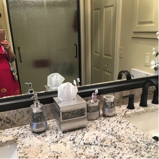 The bathroom accessory set displayed on a bathroom countertop.